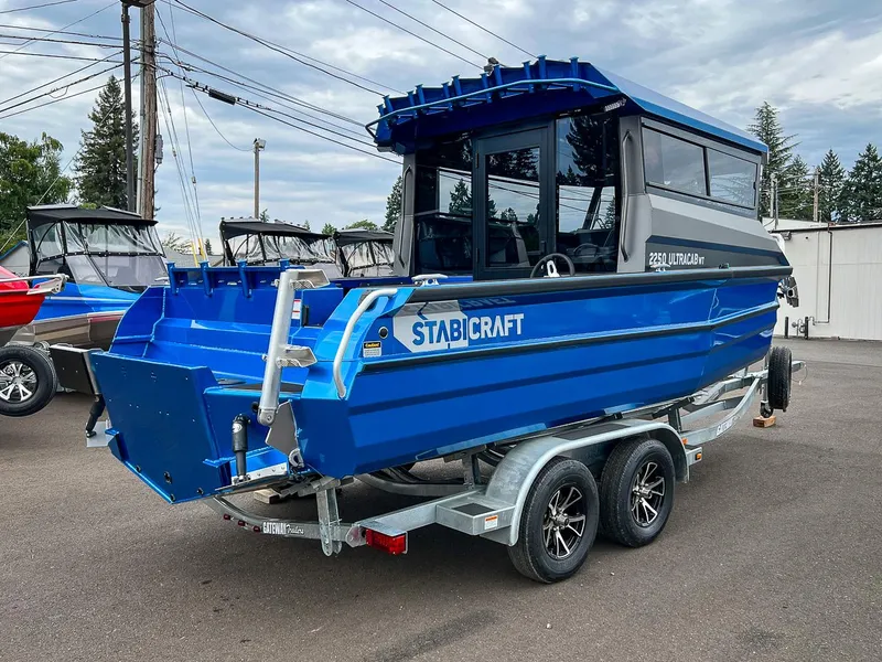 Slide: The Image of 2023 Stabicraft 2250 UltraCab WT boat on a trailer in a parking lot. - 3