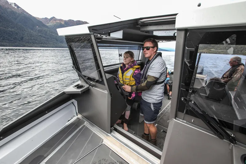 Slide: The Image of 2023 Stabicraft 2250 UltraCab WT on a scenic lake with passengers. - 8