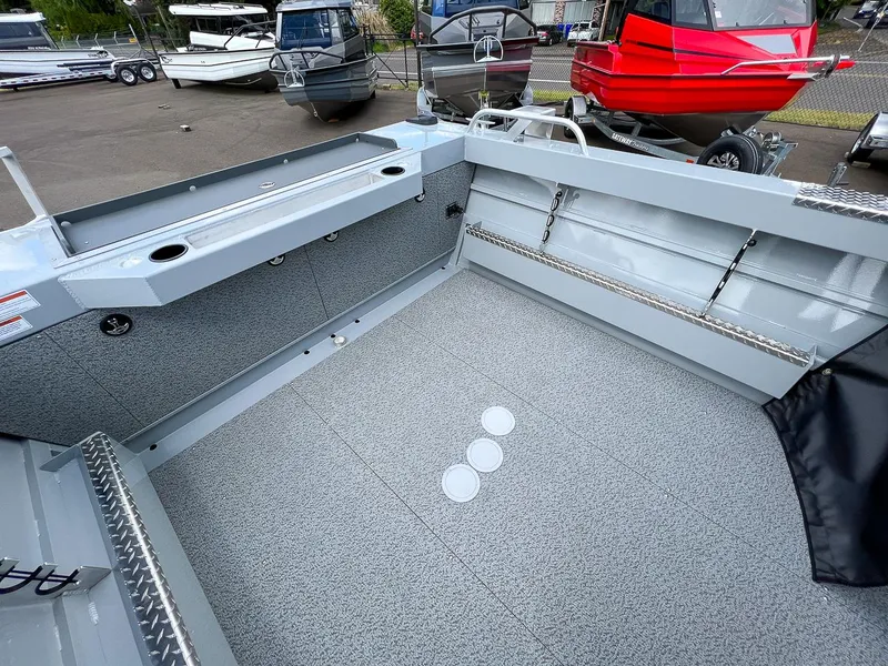 Slide: The Image of 2023 Hewescraft 200 Pro-V ET boat interior, spacious deck with storage compartments. - 14