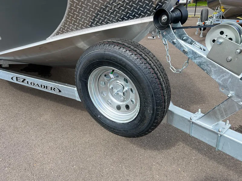 Slide: The Image of Close-up of 2023 Hewescraft 200 Pro-V ET boat trailer with EZ Loader branding. - 19