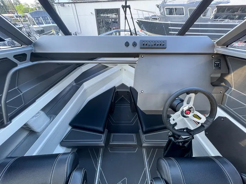 Slide: The Image of Interior of 2025 Stabicraft 2050 Supercab boat with steering wheel and seating. - 10