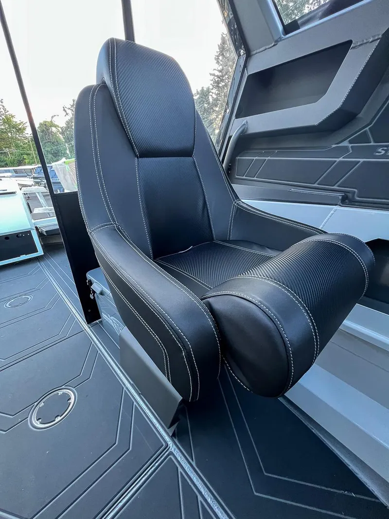 Slide: The Image of Stabicraft 2050 Supercab 2025 model interior seat with black upholstery and white stitching. - 13