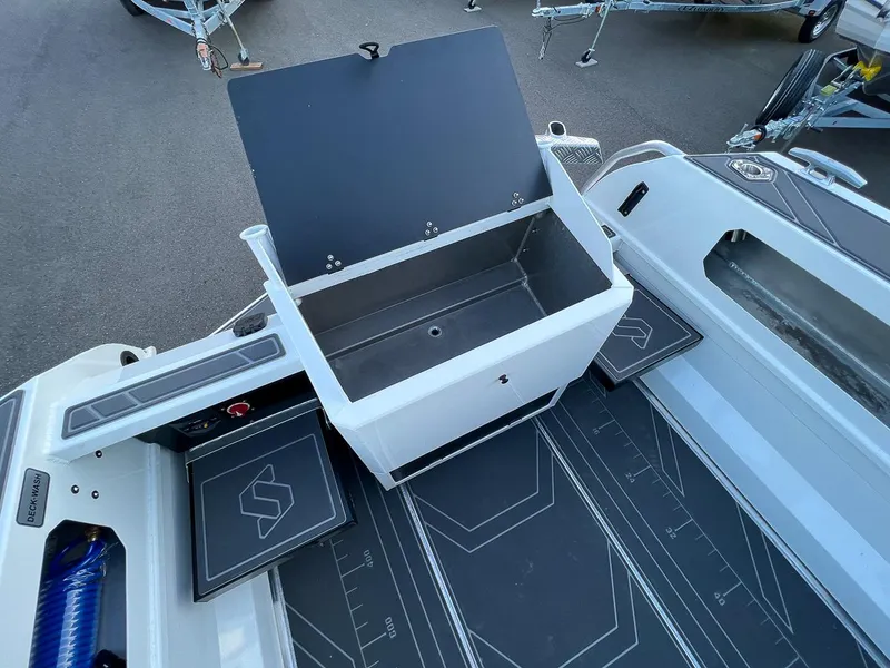 Slide: The Image of Stabicraft 2050 Supercab 2025 model interior with open storage compartment and deck wash system. - 18