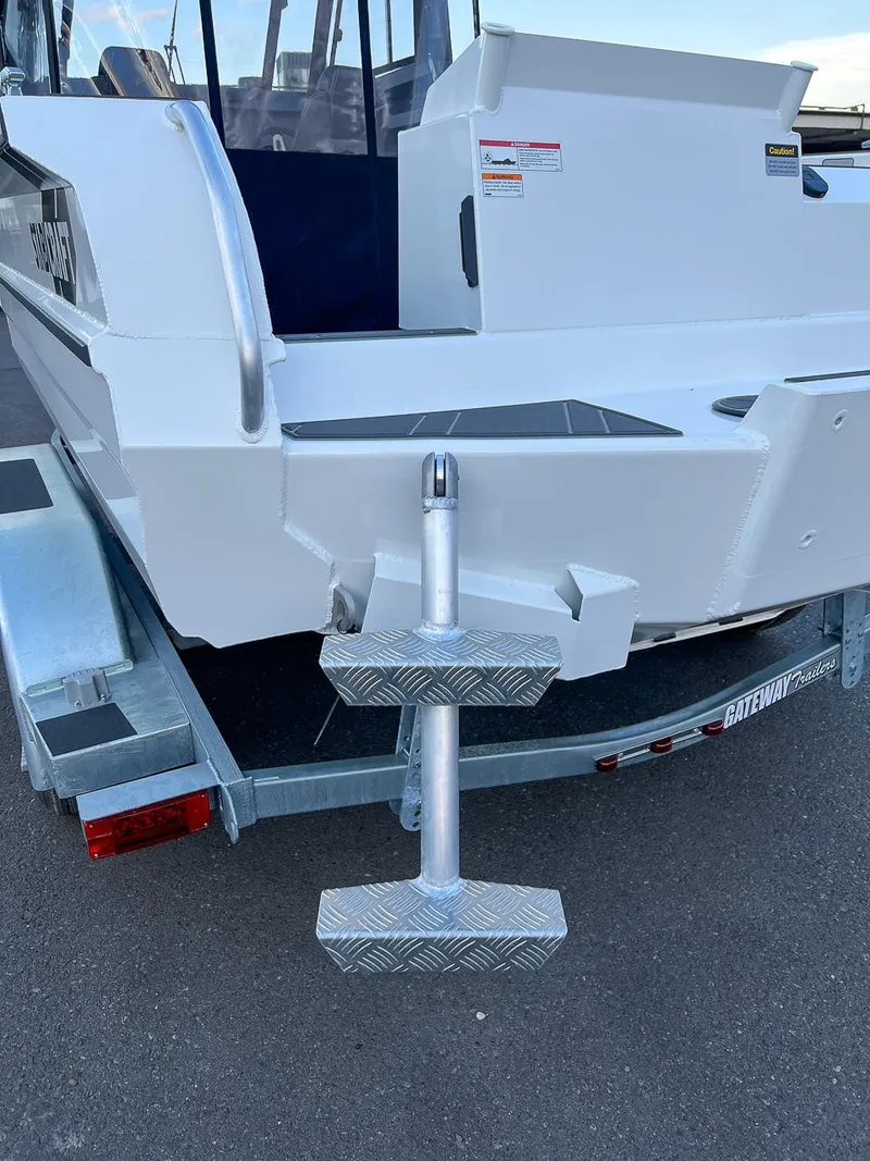 Slide: The Image of 2025 Stabicraft 2050 Supercab boat on a trailer, rear view with boarding steps. - 19