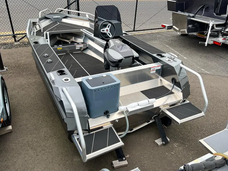 Slide: The Image of 2025 Stabicraft 1450 Frontier boat, rear view, parked on pavement. - 4