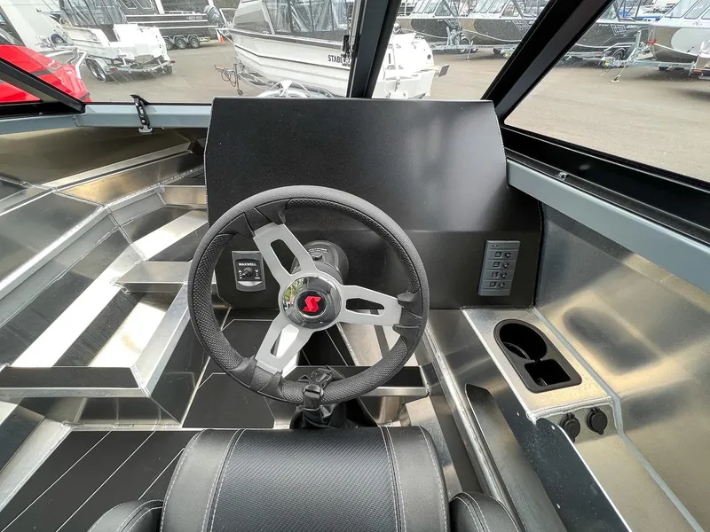 Slide: The Image of 2023 Stabicraft 1850 Fisher boat interior, featuring steering wheel and control panel. - 10