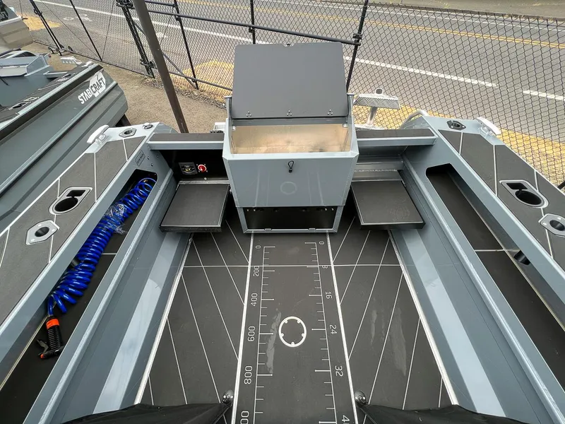 Slide: The Image of 2023 Stabicraft 1850 Fisher boat interior with storage compartments and measuring guide. - 14