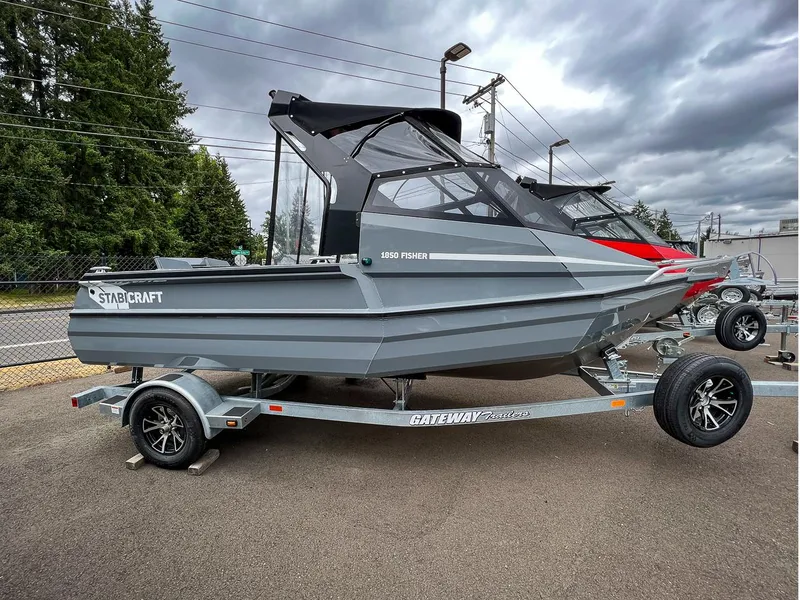 Slide: The Image of 2023 Stabicraft 1850 Fisher boat on a Gateway trailer, parked outdoors. - 2