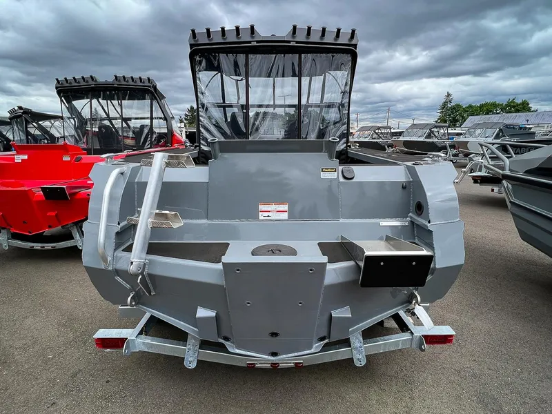 Slide: The Image of 2023 Stabicraft 1850 Fisher boat, rear view, in a boatyard with other boats. - 4