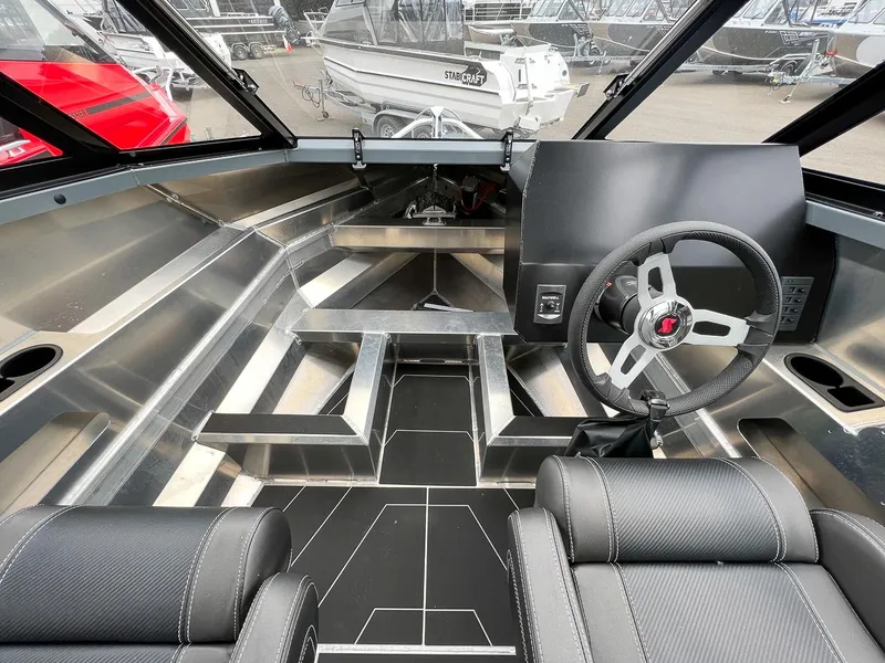 Slide: The Image of 2023 Stabicraft 1850 Fisher boat interior with steering wheel and seating. - 8