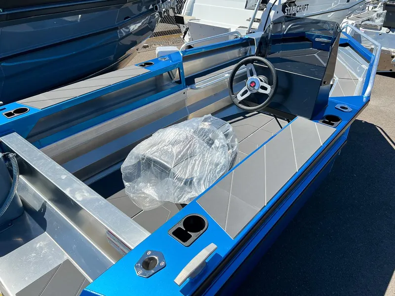 Slide: The Image of 2023 Stabicraft 1450 Frontier boat interior with steering wheel and seating. - 10
