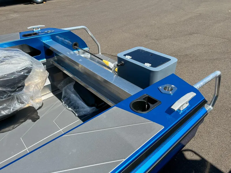 Slide: The Image of 2023 Stabicraft 1450 Frontier boat interior, blue and gray detailing, cup holders, and storage compartments. - 12