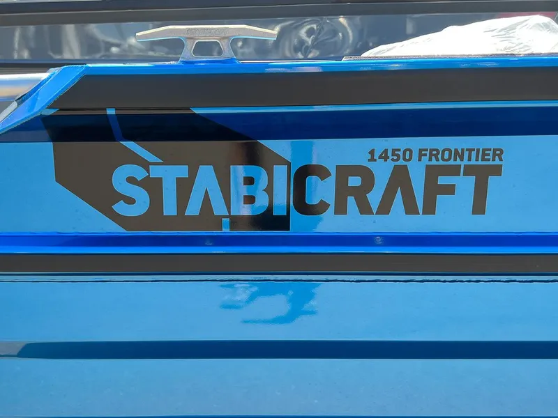 Slide: The Image of 2023 Stabicraft 1450 Frontier boat logo on blue hull. - 13