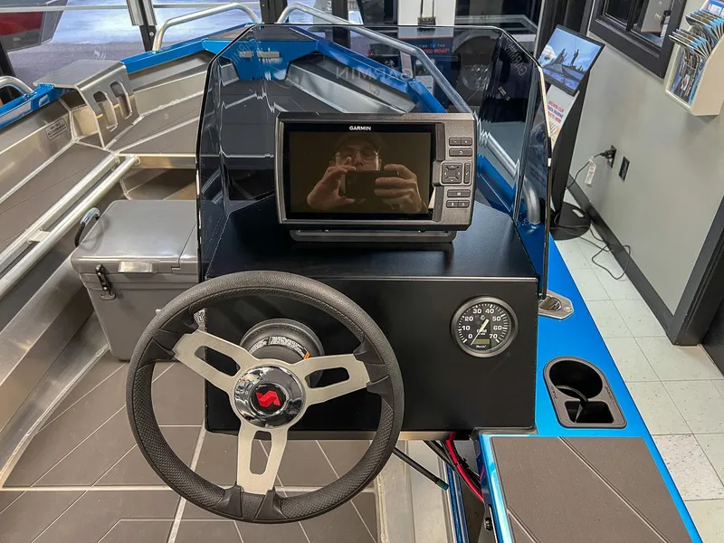 Slide: The Image of 2023 Stabicraft 1450 Frontier boat dashboard with Garmin display and steering wheel. - 4
