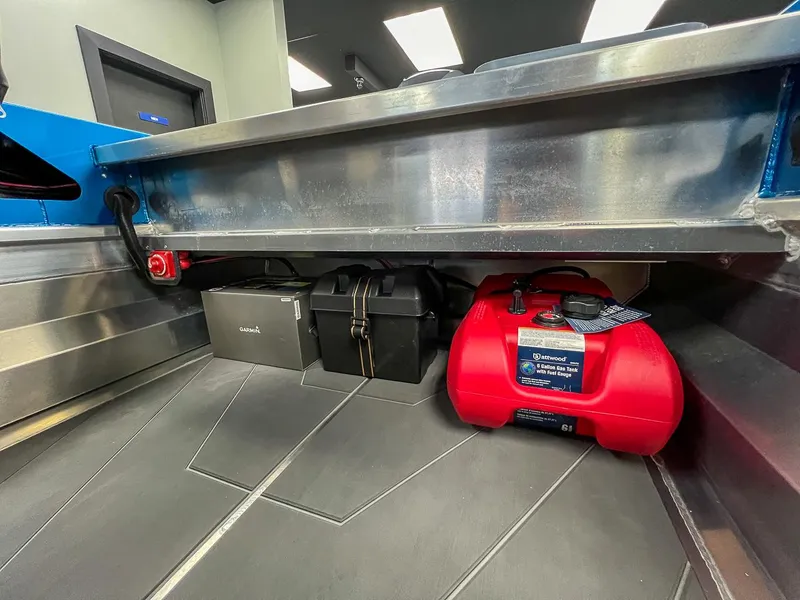 Slide: The Image of 2023 Stabicraft 1450 Frontier storage area with Garmin box and red gas tank. - 5