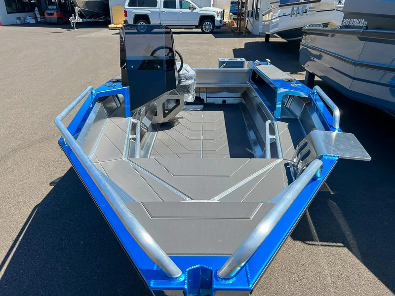 Slide: The Image of 2023 Stabicraft 1450 Frontier boat, blue exterior, displayed in a showroom. - 7
