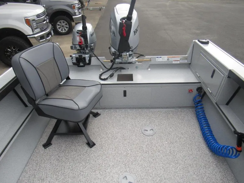 Slide: The Image of Interior of 2024 Alumaweld 20 Adventurer boat with seating and Honda outboard motor. - 11