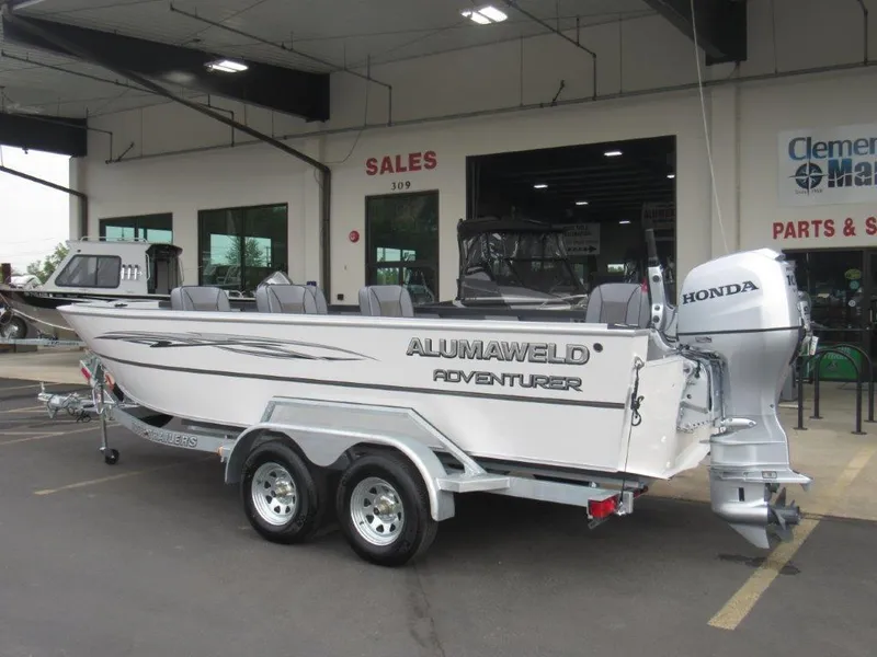 Slide: The Image of 2024 Alumaweld 20 Adventurer boat with Honda outboard motor on trailer. - 3