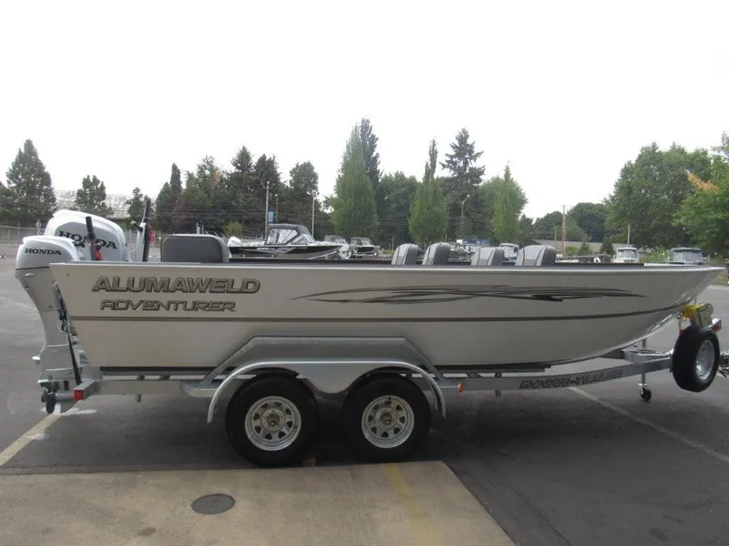 Slide: The Image of 2024 Alumaweld 20 Adventurer boat on trailer with Honda outboard motor. - 6