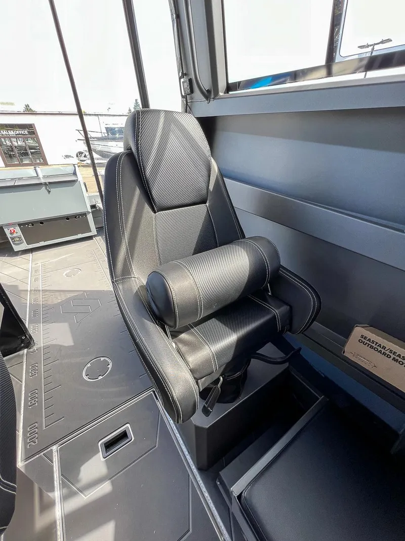 Slide: The Image of 2023 Stabicraft 2250 Ultra Centercab interior with black captain's chair and detailed flooring. - 11