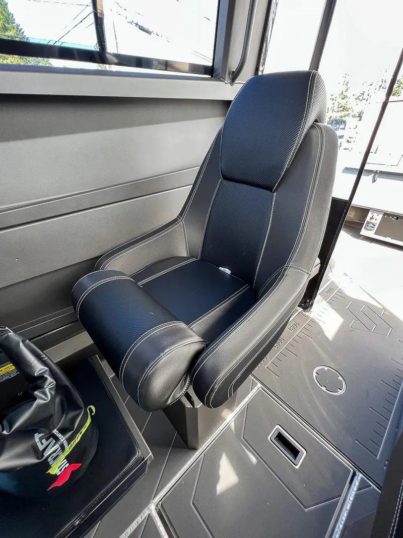 Slide: The Image of 2023 Stabicraft 2250 Ultra Centercab interior seat with black upholstery and white stitching. - 12