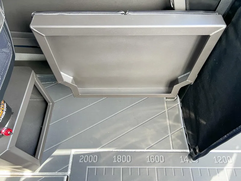 Slide: The Image of 2023 Stabicraft 2250 Ultra Centercab interior with foldable seat and measurement markings. - 15