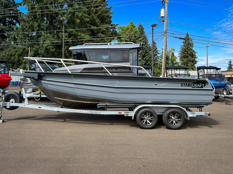 Slide: The Image of 2023 Stabicraft 2250 Ultra Centercab boat on a trailer in a parking lot. - 2
