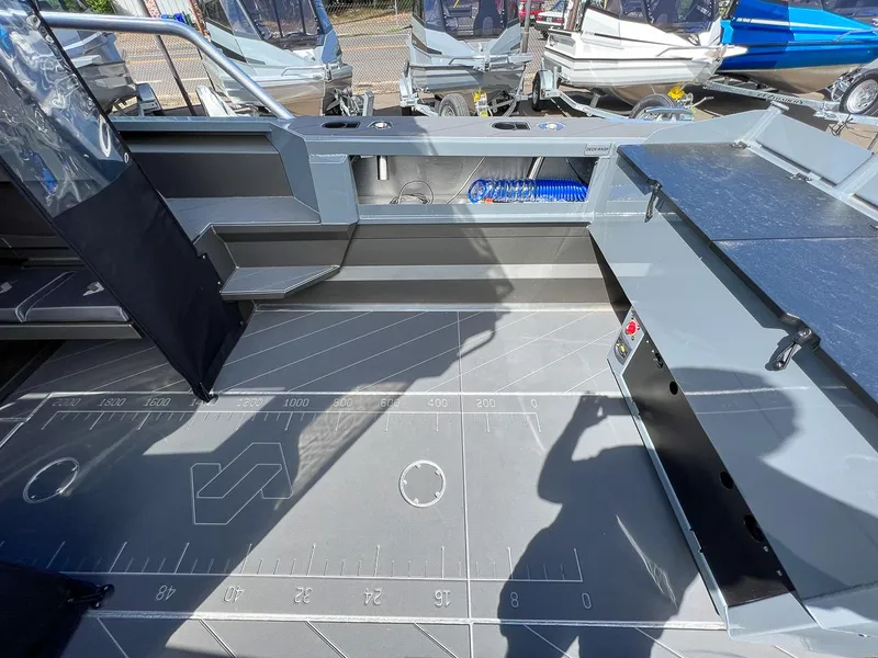 Slide: The Image of 2023 Stabicraft 2250 Ultra Centercab interior, showcasing spacious deck and storage compartments. - 21