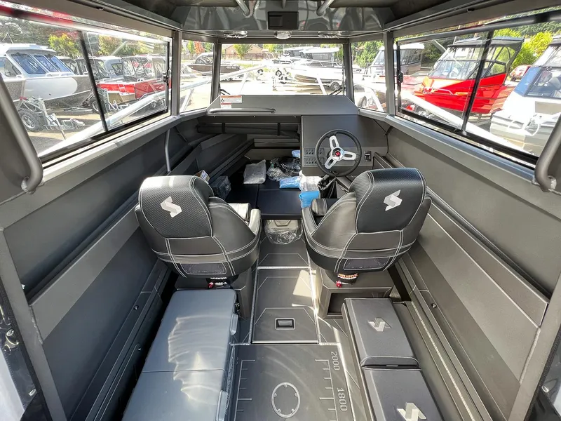 Slide: The Image of Interior of 2023 Stabicraft 2250 Ultra Centercab boat with dual seats and steering wheel. - 7