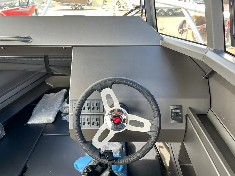 Slide: The Image of Interior helm of 2023 Stabicraft 2250 Ultra Centercab boat with steering wheel and control panel. - 8