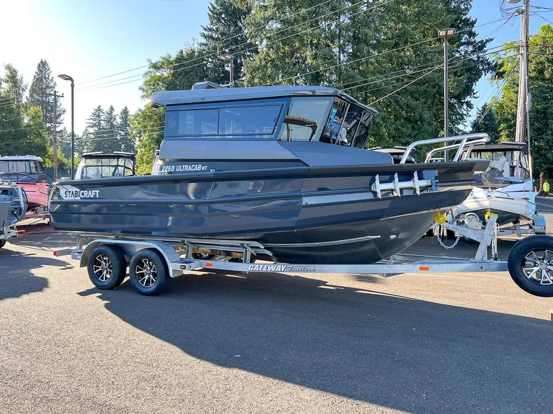 Slide: The Image of 2023 Stabicraft 2250 UltraCab WT boat on a trailer in a parking lot. - 1