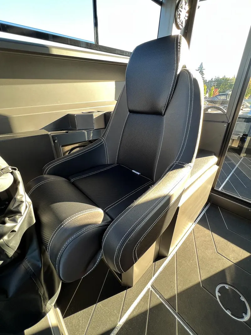 Slide: The Image of Captain's seat in 2023 Stabicraft 2250 UltraCab WT boat, black upholstery with white stitching. - 13