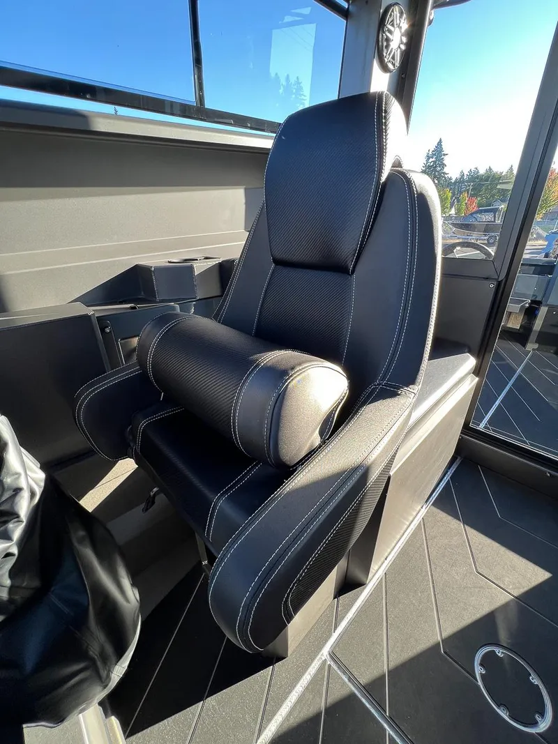 Slide: The Image of Captain's seat in 2023 Stabicraft 2250 UltraCab WT boat, black upholstery with white stitching. - 14