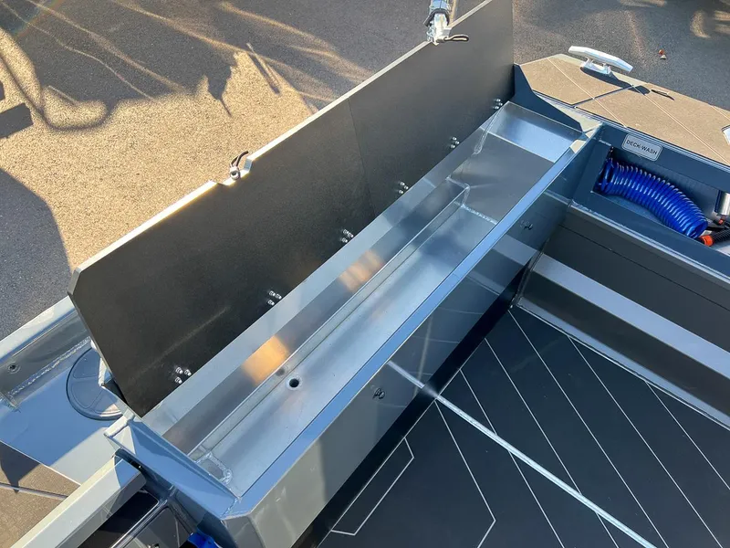 Slide: The Image of 2023 Stabicraft 2250 UltraCab WT deck with storage compartment and deck wash system. - 21