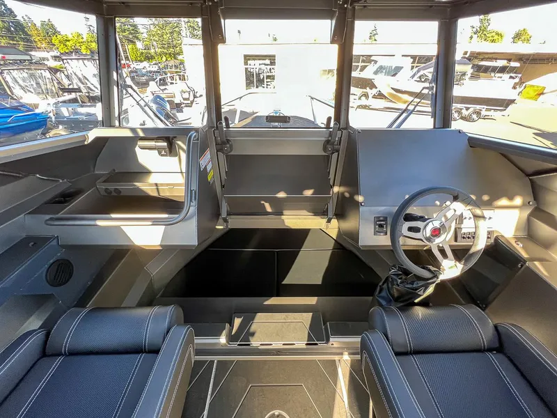 Slide: The Image of 2023 Stabicraft 2250 UltraCab WT interior with steering wheel and seating. - 9