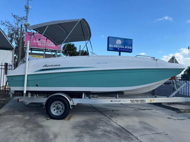 Slide: The Image of 2024 Hurricane SunDeck Sport 188 OB boat on trailer with canopy. - 0