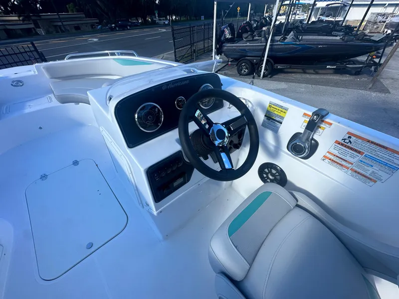 Slide: The Image of 2024 Hurricane SunDeck Sport 188 OB boat cockpit with steering wheel and controls. - 3