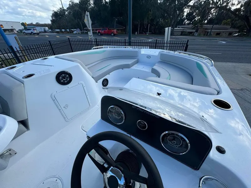 Slide: The Image of 2024 Hurricane SunDeck Sport 188 OB boat interior with steering wheel and seating area. - 5