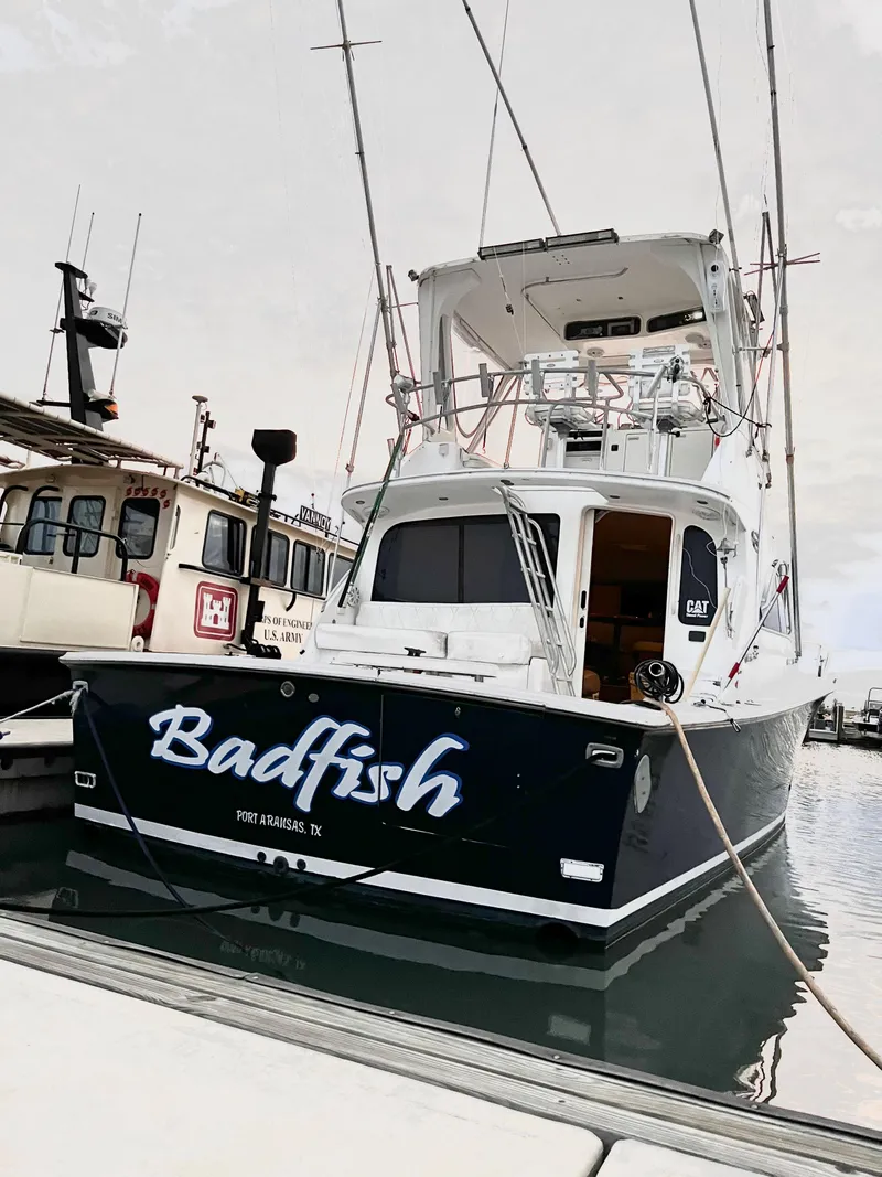 Slide: The Image of 1998 Ocean Yachts 40 Super Sport docked at marina, named Badfish. - 1