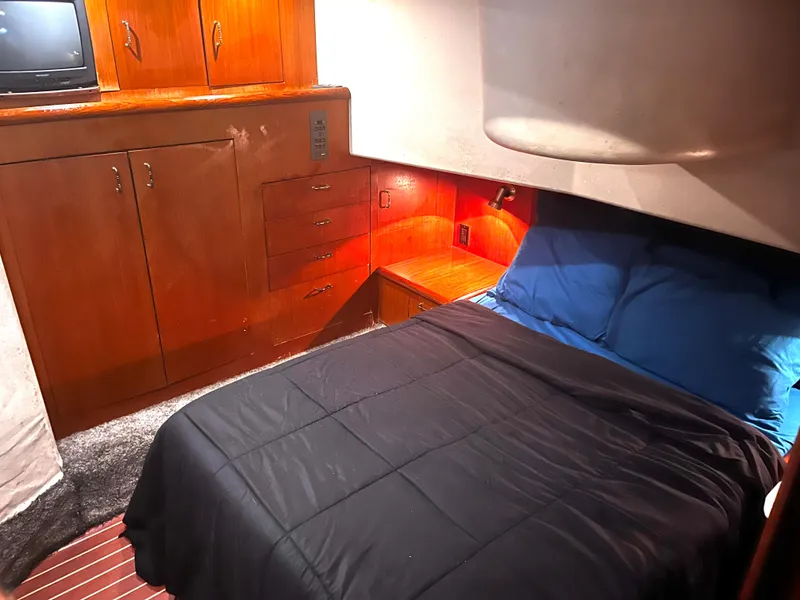 Slide: The Image of Cozy bedroom in 1998 Ocean Yachts 40 Super Sport with wooden cabinetry. - 10