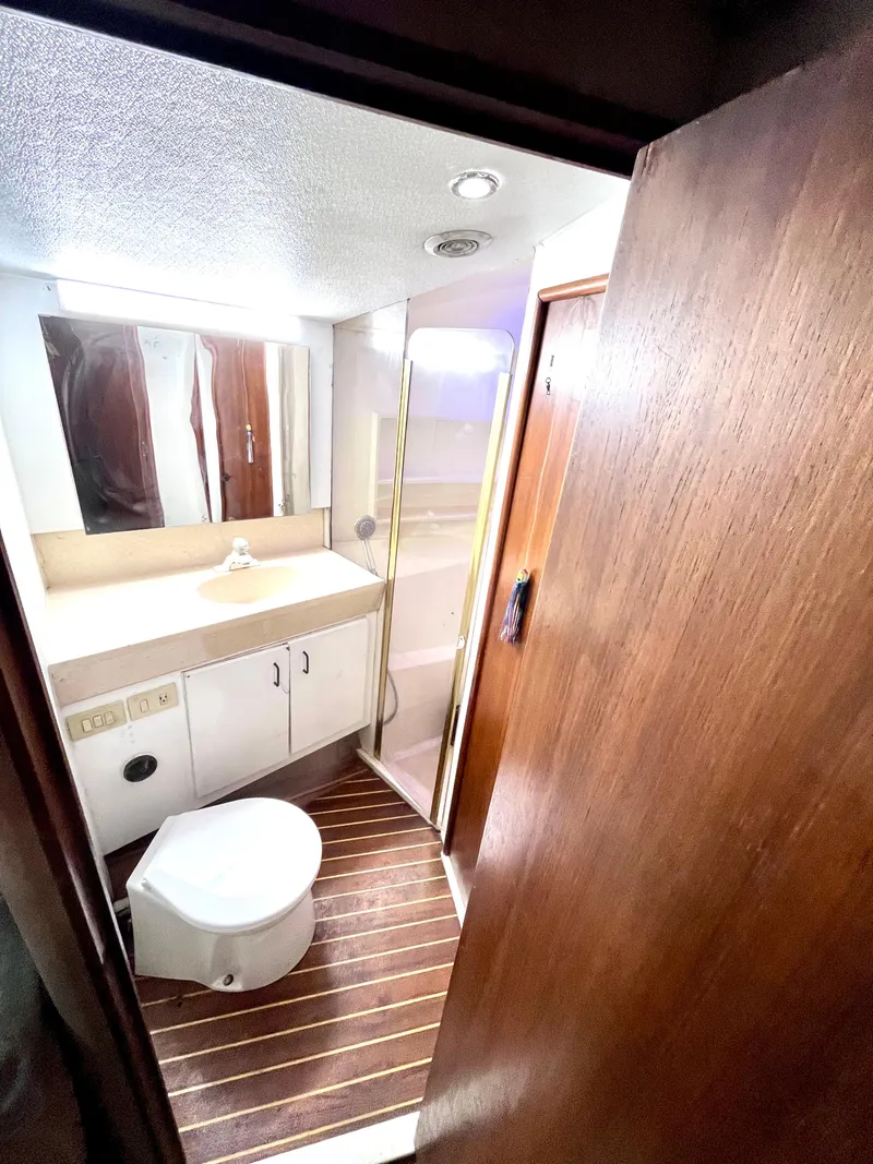Slide: The Image of 1998 Ocean Yachts 40 Super Sport bathroom with sink, toilet, and shower. - 11
