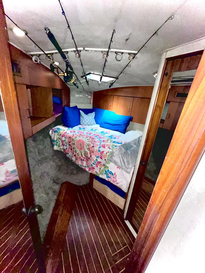 Slide: The Image of 1998 Ocean Yachts 40 Super Sport cabin with bed and fishing rods. - 12