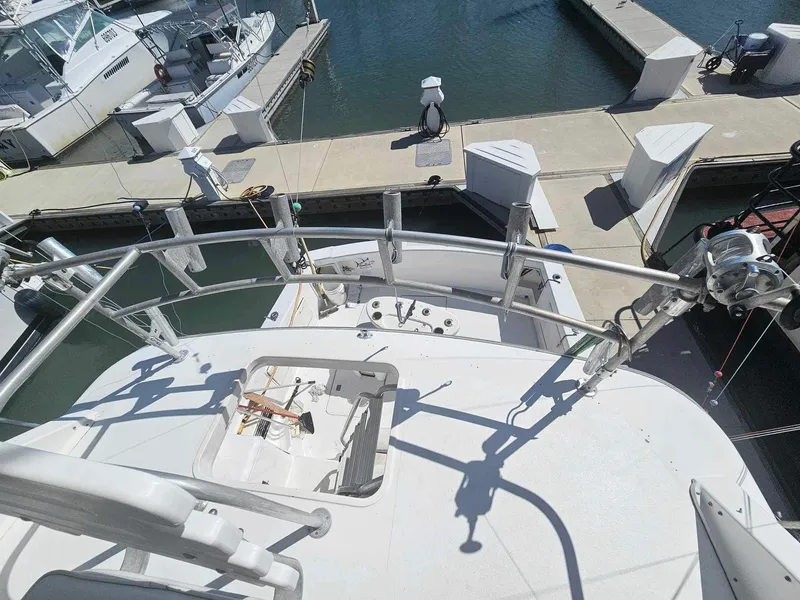 Slide: The Image of 1998 Ocean Yachts 40 Super Sport docked at a marina, view from upper deck. - 13