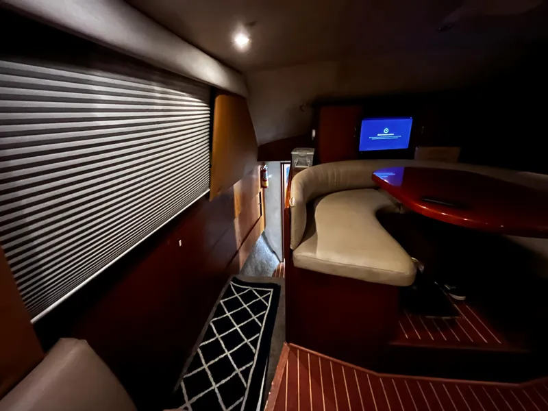 Slide: The Image of Interior of 1998 Ocean Yachts 40 Super Sport with seating area and TV. - 9