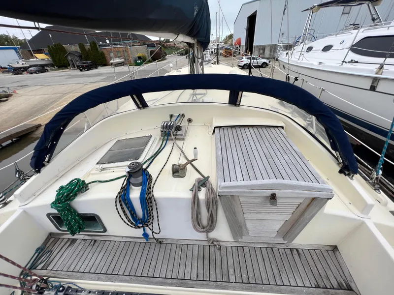 Slide: The Image of 1986 Krogen 38 sailboat deck with ropes and winches in a marina. - 14