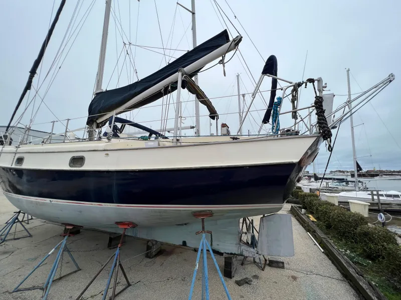 Slide: The Image of 1986 Krogen 38 sailboat on stands in a marina. - 2