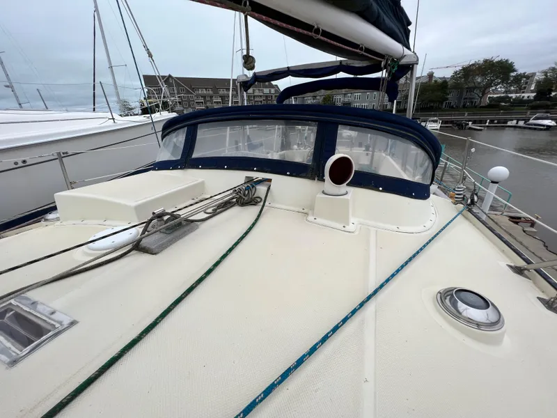 Slide: The Image of 1986 Krogen 38 sailboat deck with blue canvas and rigging. - 20