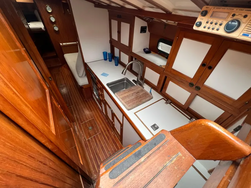 Slide: The Image of 1986 Krogen 38 yacht interior with wooden cabinetry and galley kitchen. - 21