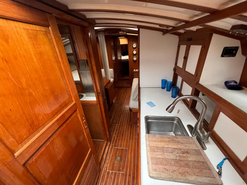 Slide: The Image of 1986 Krogen 38 interior with wooden cabinetry and galley kitchen. - 22