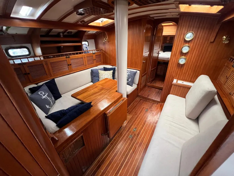 Slide: The Image of 1986 Krogen 38 yacht interior with wooden finish and cozy seating area. - 25